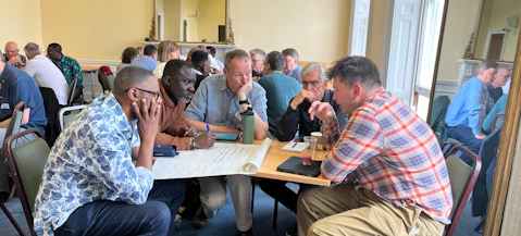 A diverse group of leaders discuss leadership development at a Global Connections Event