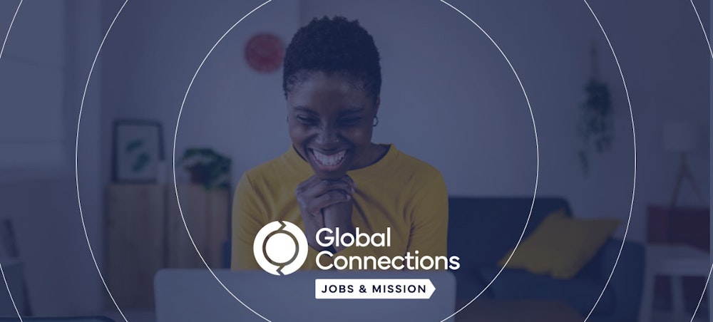 A woman celebrates finding a job through Global Connections Jobs and Mission