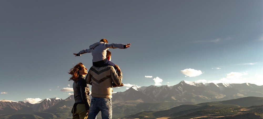 Family looking at mountains deciding on short-term programme