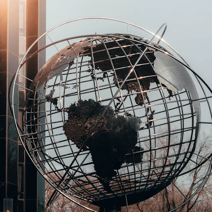 Metal globe with wire linking contents demonstrating related networks.