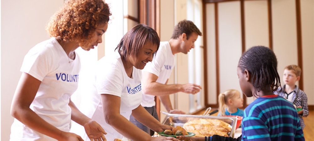 A group of short term volunteers feed people