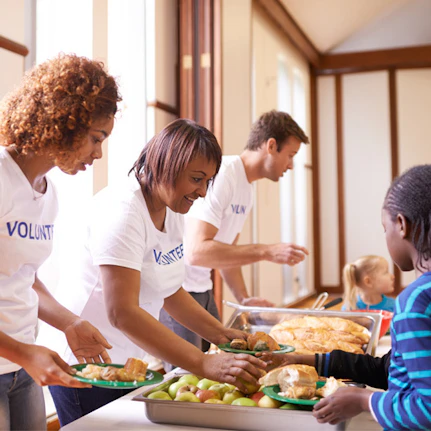 A group of volunteers feed hungry people