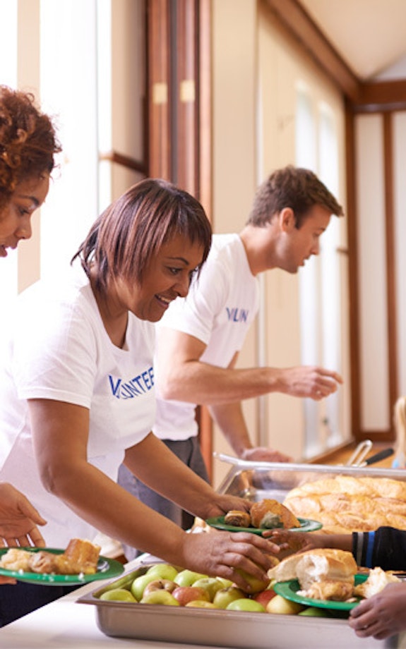 A group of volunteers feed hungry people