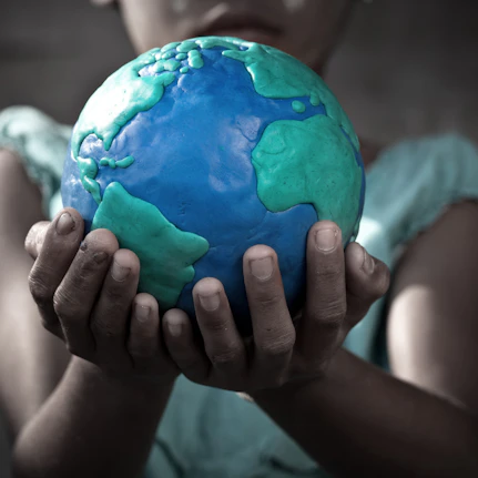 A child holding the world in their hand