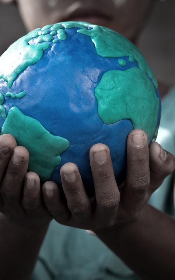 A child holding the world in their hand