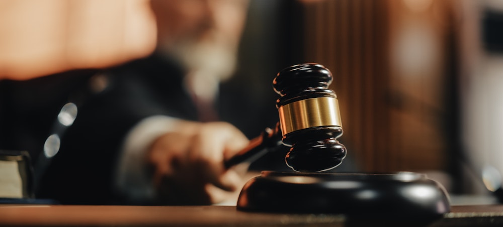 Hand with judge's employment law hammer