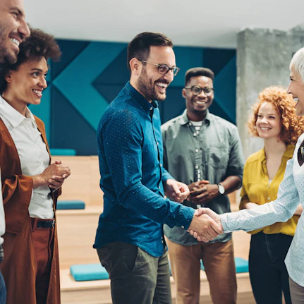Group of people shaking hands to join the network.