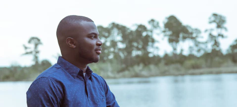 Man looking out over a river making the most of his short term experience.
